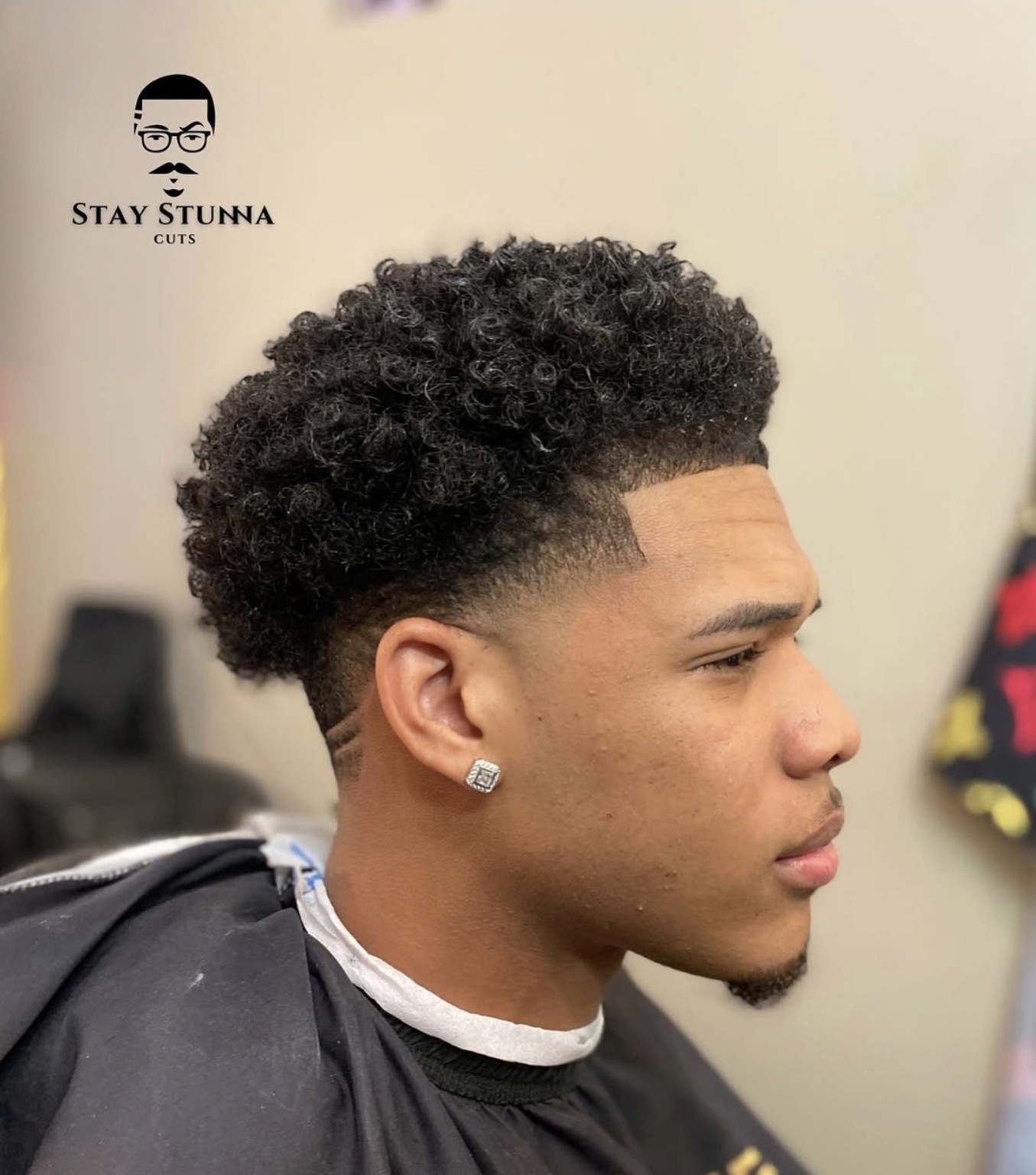 Krullende coupe met hoge fade